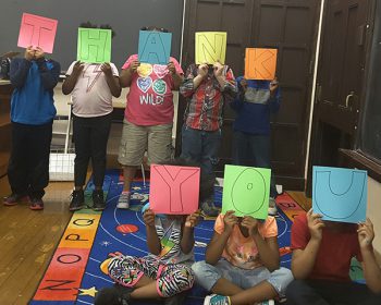 Kids holding Thank You signs